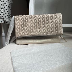 Stella and Dot leather, creams woven detail. Shoulder strap.